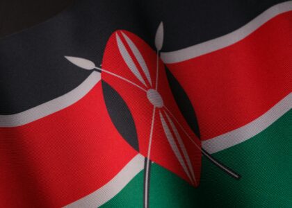 Detailed close-up of the vibrant Kenyan flag waving with texture visible.